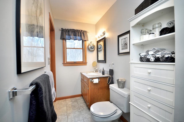 bathroom featuring tile patterned floors, vanity, and toilet