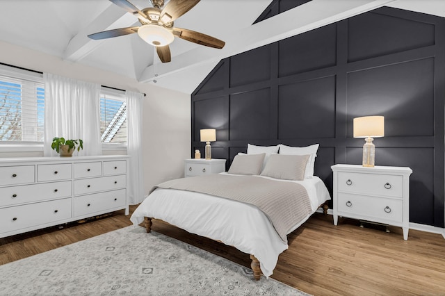 bedroom with vaulted ceiling with beams, wood-type flooring, and ceiling fan