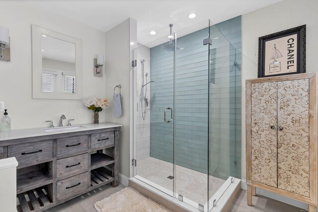 bathroom with vanity, an enclosed shower, and tile patterned floors