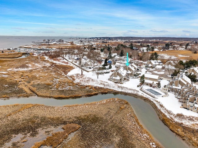 snowy aerial view with a water view