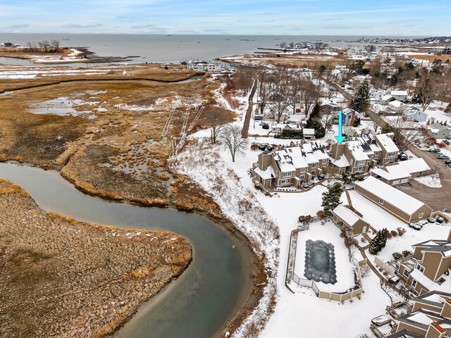 snowy aerial view with a water view