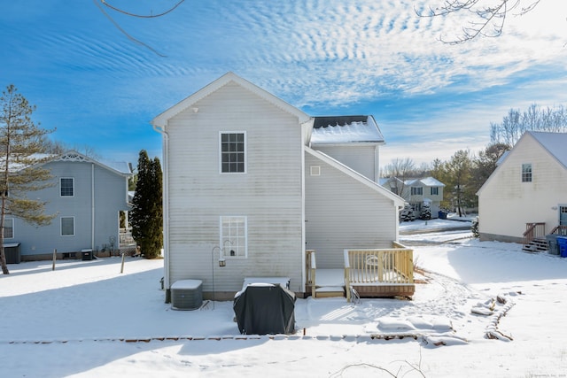 snow covered rear of property with central air condition unit