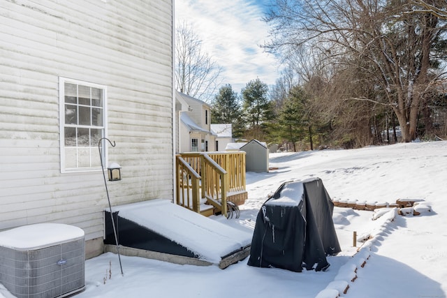 yard layered in snow with a storage unit