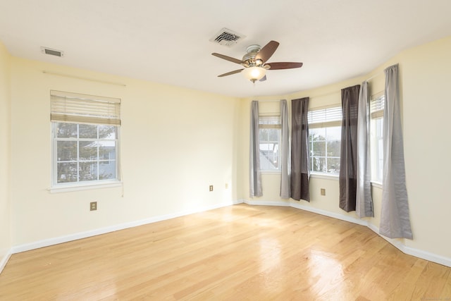 spare room featuring ceiling fan, plenty of natural light, and light hardwood / wood-style floors