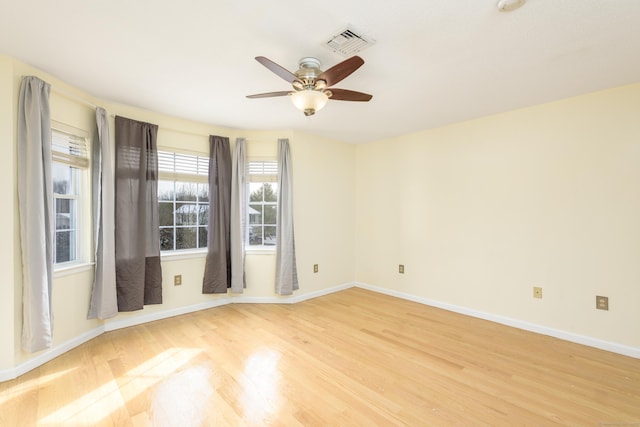 spare room with light hardwood / wood-style flooring and ceiling fan