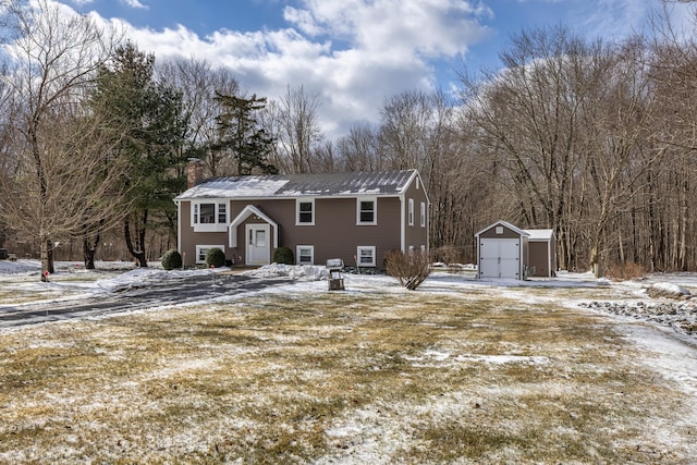 view of front of home featuring a storage shed