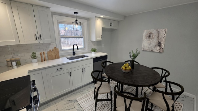 kitchen featuring sink, hanging light fixtures, white cabinets, stainless steel appliances, and backsplash