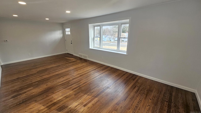 spare room with dark hardwood / wood-style floors