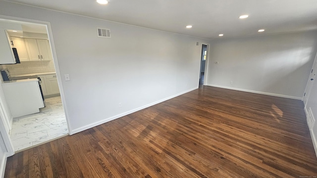 spare room featuring hardwood / wood-style flooring