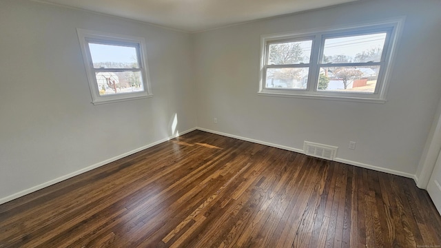 empty room with dark wood-type flooring