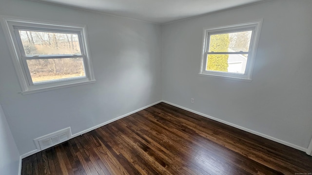 empty room with dark wood-type flooring