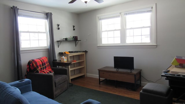 interior space with dark wood-type flooring and ceiling fan