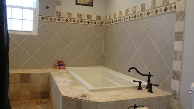 bathroom with tiled tub