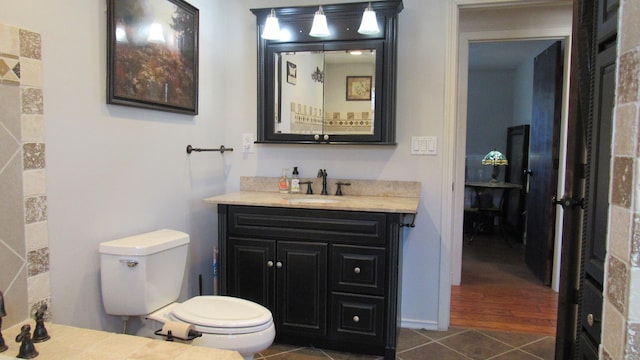 bathroom with vanity, tile patterned floors, and toilet