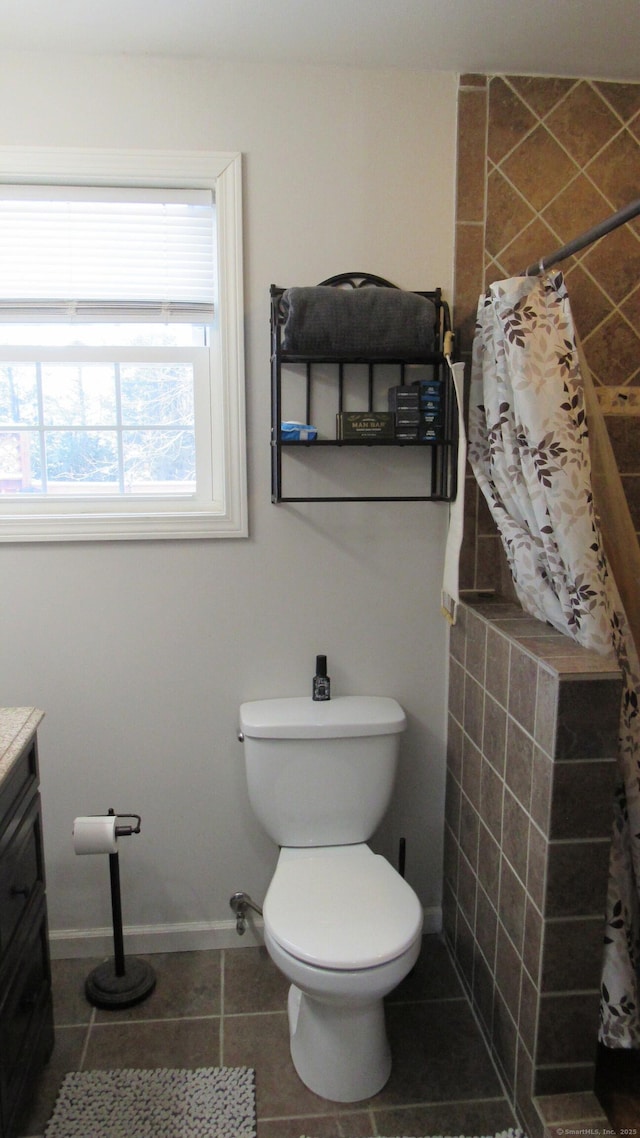 bathroom featuring vanity, tile patterned flooring, and toilet