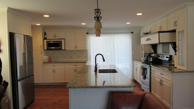 kitchen featuring white cabinetry, hanging light fixtures, sink, and appliances with stainless steel finishes