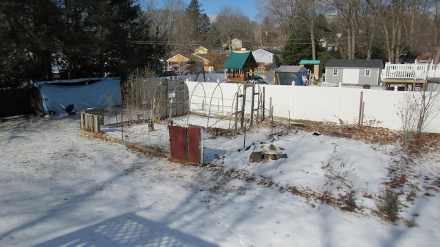 yard covered in snow with a playground