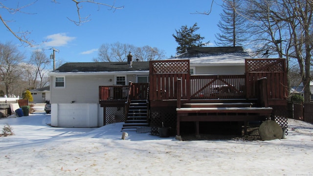 snow covered property with a deck