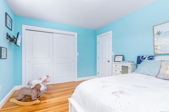 bedroom with hardwood / wood-style flooring and a closet