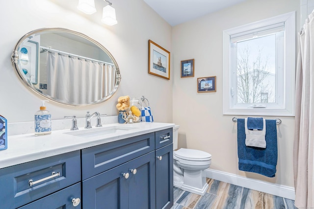 bathroom with vanity, hardwood / wood-style flooring, and toilet