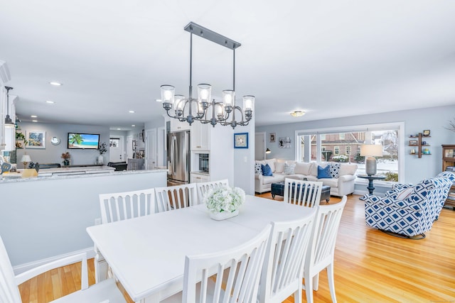 dining room featuring an inviting chandelier and light hardwood / wood-style floors