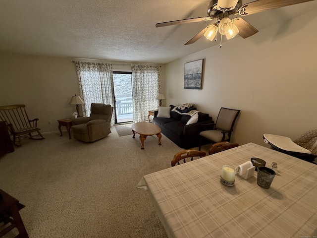 carpeted living room with ceiling fan and a textured ceiling