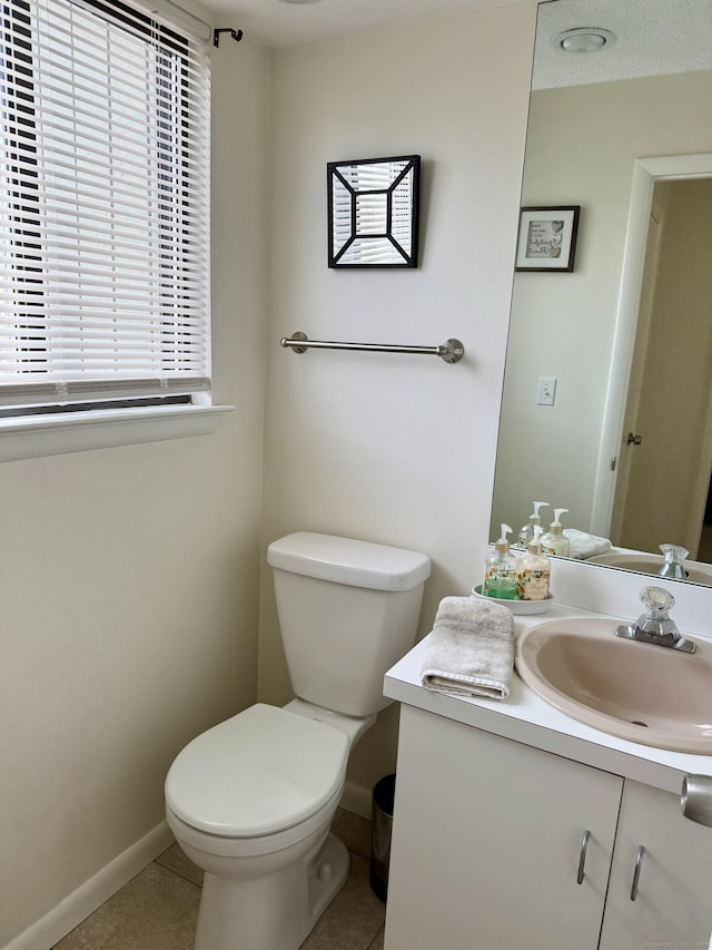 bathroom featuring vanity, tile patterned floors, and toilet