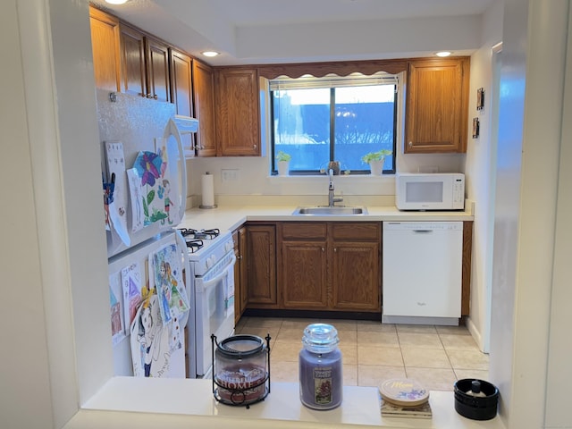 kitchen featuring sink, light tile patterned floors, and white appliances