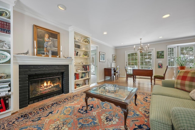 living room with an inviting chandelier, crown molding, a wealth of natural light, and light hardwood / wood-style floors