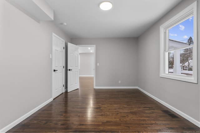 unfurnished bedroom with dark hardwood / wood-style floors