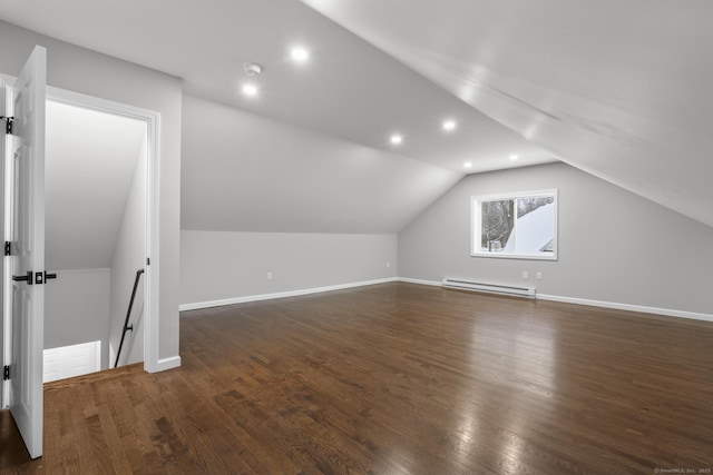 bonus room featuring lofted ceiling, a baseboard heating unit, and dark hardwood / wood-style flooring