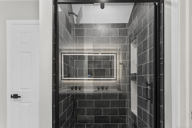 bathroom featuring a shower with door