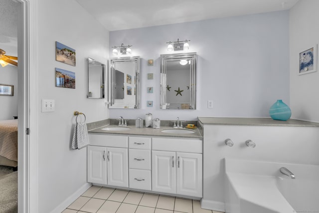 ensuite bathroom featuring double vanity, ensuite bath, a sink, and tile patterned floors