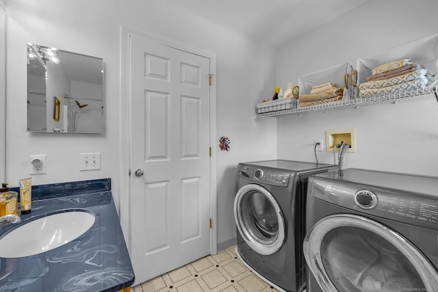 laundry area featuring laundry area, a sink, and independent washer and dryer