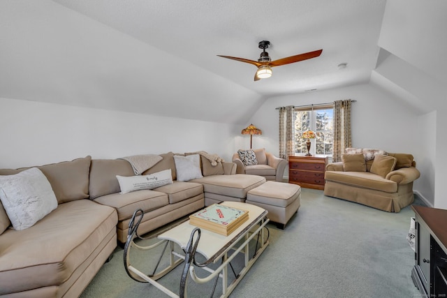 carpeted living area with lofted ceiling and a ceiling fan