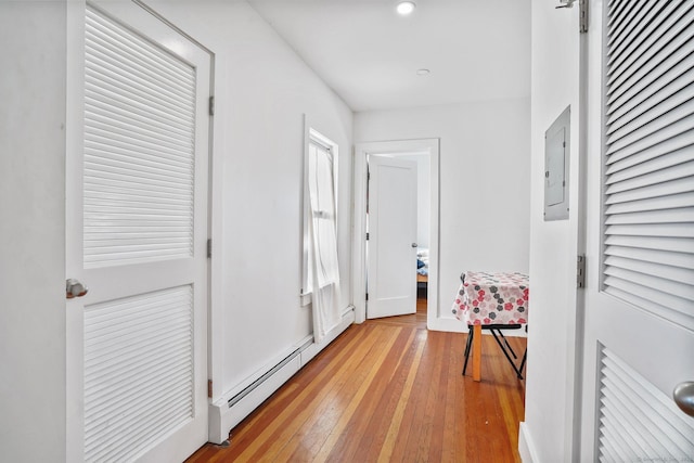 hall featuring a baseboard radiator, electric panel, and light hardwood / wood-style floors