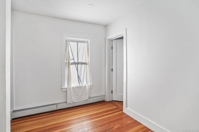 spare room with light hardwood / wood-style floors and baseboard heating