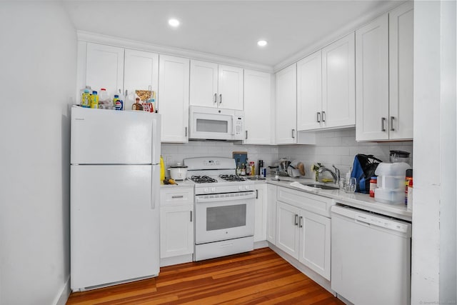 kitchen featuring sink, white appliances, and white cabinets