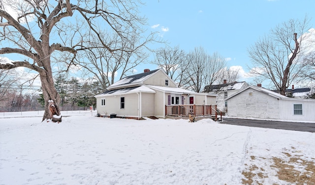 snow covered property featuring a deck