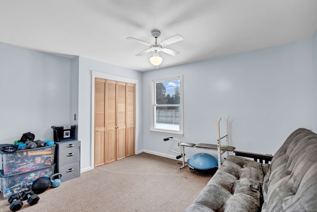 living area featuring ceiling fan and carpet