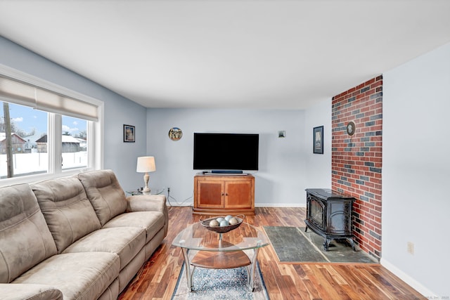 living room featuring hardwood / wood-style flooring and a wood stove