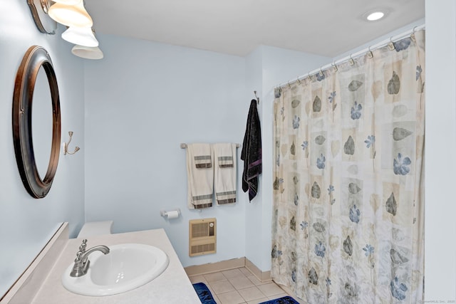 bathroom featuring walk in shower, tile patterned floors, heating unit, and vanity