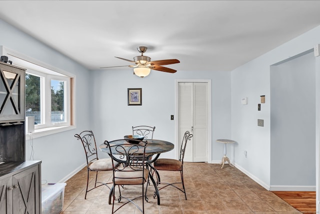 dining space with light tile patterned flooring and ceiling fan