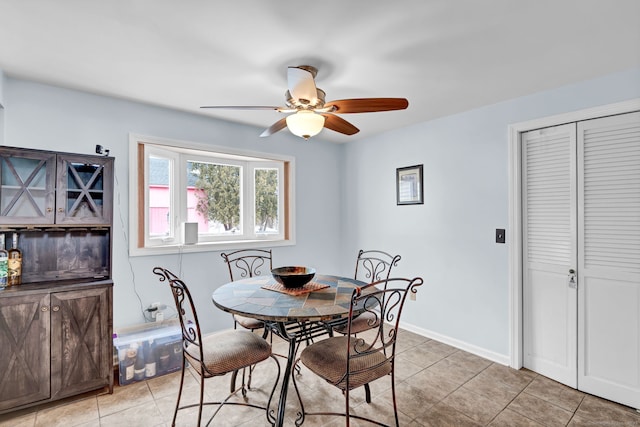 tiled dining room with ceiling fan