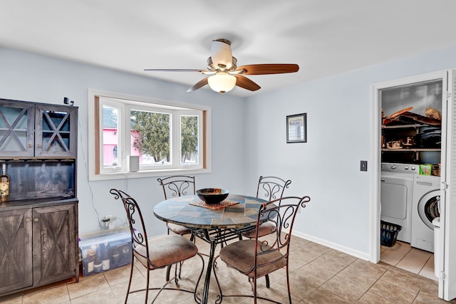 dining space with independent washer and dryer, ceiling fan, and light tile patterned flooring