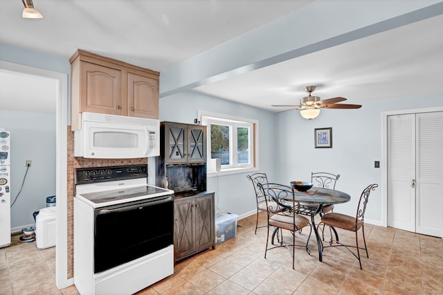 kitchen featuring electric stove, light brown cabinetry, light tile patterned floors, and ceiling fan