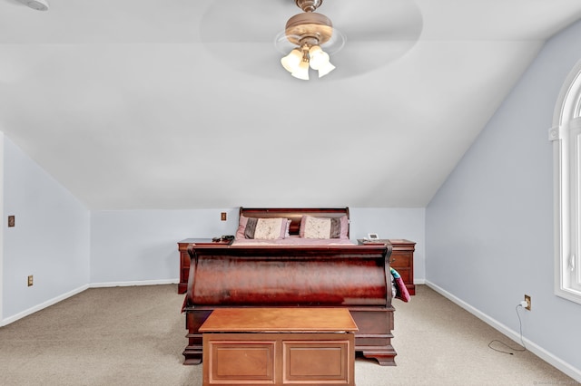 bedroom featuring ceiling fan, light colored carpet, and lofted ceiling