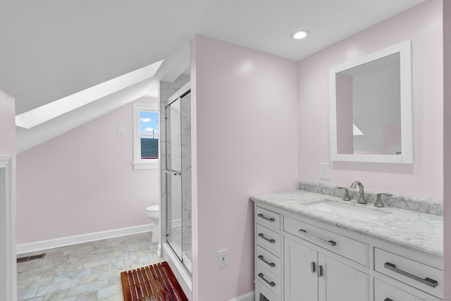 bathroom with walk in shower, vanity, toilet, and vaulted ceiling with skylight