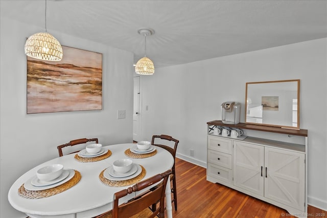 dining space with baseboards and dark wood-style floors