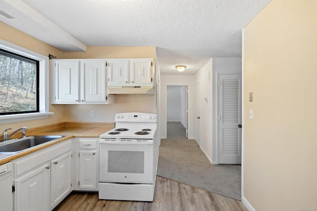 kitchen featuring sink, white cabinets, white appliances, light hardwood / wood-style floors, and a textured ceiling